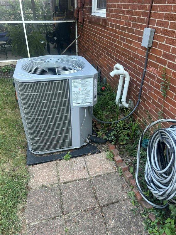 Responded to no-cooling complaint on one-year-old air conditioning system. Upon arrival, conducted visual inspection of outdoor condensing unit and associated refrigerant lines. Unit appeared properly installed on concrete paver pad with appropriate clearances. Observed significant corrosion on refrigerant line set entering crawlspace, indicating potential leak point. Corroded piping showed advanced oxidation consistent with moisture exposure and inadequate line protection. Performed system diagnostics and identified refrigerant leak at corroded section of line set. Repaired leak, evacuated system, and recharged to manufacturer specifications. Verified proper system operation with normal temperature differential and adequate airflow. Unit restored to full cooling capacity.