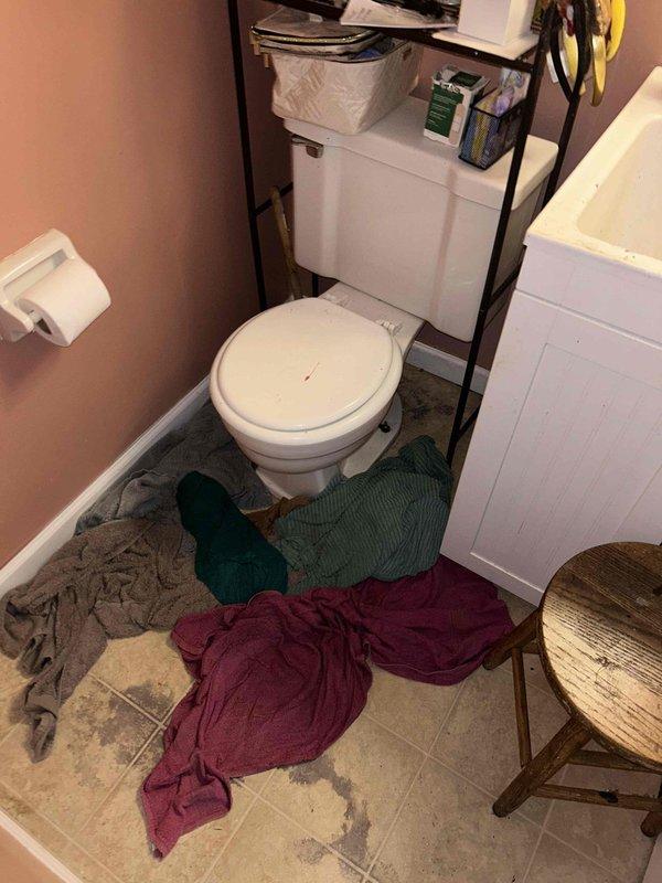 Responded to emergency call for sewage backup in basement bathroom where wastewater discharged from toilet onto floor during upstairs shower use. Upon arrival, assessed bathroom area affected by backup and identified potential main sewer line obstruction. Documented existing conditions including water damage to bathroom floor and placed temporary absorbent materials to contain affected area.