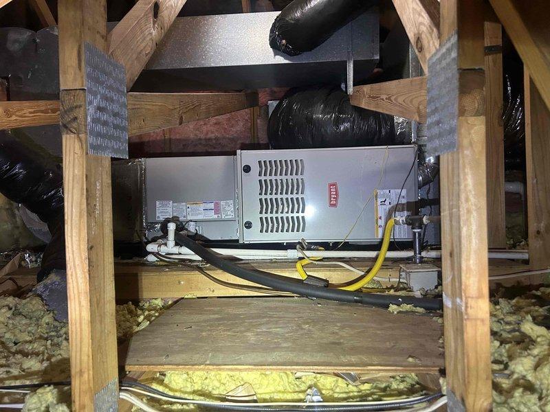 Responded to no-cooling call on 6-year-old electric HVAC system. Upon arrival, found thermostat display was blank due to depleted batteries, which were replaced to restore display functionality. Proceeded with diagnostic testing of outdoor condensing unit. Using digital clamp meter, measured microamp reading of 0.62 at the capacitor, indicating failed run capacitor preventing compressor and condenser fan motor operation. Inspected dual run capacitor and associated contactor wiring connections. Verified all electrical connections were secure with proper wire terminations to capacitor terminals and contactor. Inspected indoor air handler unit located in attic space, noting dirty air filter requiring replacement. Confirmed ductwork and electrical connections at indoor unit were intact. Recommended capacitor replacement to restore cooling operation and immediate filter replacement to ensure proper airflow and system efficiency.