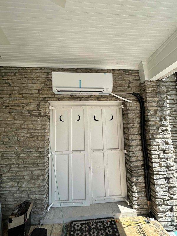 Completed full installation of Mitsubishi 24K BTU Hyper Heat mini split system consisting of MUZ-GX24NLHZ outdoor condenser unit and MSZ-GX24NL indoor wall-mounted air handler. Installed outdoor unit on concrete pad with vibration dampening and snow legs for elevated positioning. Mounted indoor wall unit in covered outdoor entryway area with refrigerant lines routed along exterior wall. Ran and insulated refrigerant line set between indoor and outdoor units. Installed dedicated electrical circuit including disconnect box and electrical whip kit for proper power supply to system. Completed all electrical connections, refrigerant charging, and system commissioning. Tested system operation and verified proper heating and cooling performance. Obtained necessary permits and ensured all work met code compliance standards. Removed and disposed of existing equipment. Enrolled system in annual care maintenance plan for ongoing service.