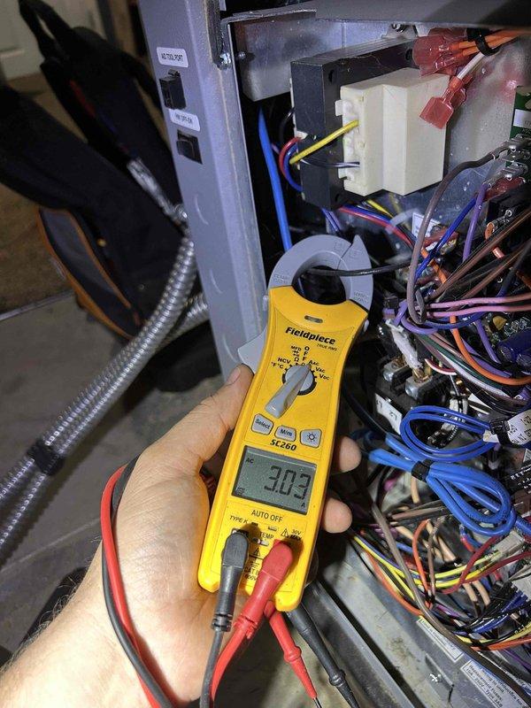 Responded to service alert on 10-11 year old WaterFurnace geothermal system. Upon inspection, found significant dust accumulation on squirrel cage blower wheel and internal components affecting system performance. Performed diagnostic testing using digital multimeter, confirming electrical parameters reading 30.5 volts within acceptable range. Replaced air filter as requested and cleaned blower assembly to restore proper airflow. System operational and alert cleared upon completion of service.