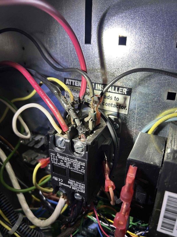 Responded to no airflow complaint on downstairs ClimateMaster Tranquility 22 geothermal heat pump system showing 10-degree temperature differential with thermostat calling for second stage cooling. Upon inspection, found electrical contactor issue related to recent Symphony monitoring device installation. Verified proper wiring connections to contactor terminals, corrected compromised connections, and restored system operation with normal airflow and cooling capacity.