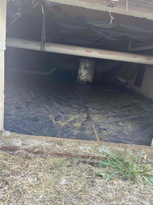 Responded to no-cool complaint on 7-year-old electric air conditioning system where indoor temperature had reached 82 degrees with minimal airflow. Evaluated outdoor condensing unit positioned on concrete pad with proper electrical disconnect and meter connections. Assessed indoor air handler system located in crawlspace with accessible PVC drainage lines and vapor barrier installation. Provided comprehensive replacement estimate for complete HVAC system due to cooling failure and inadequate air circulation performance.