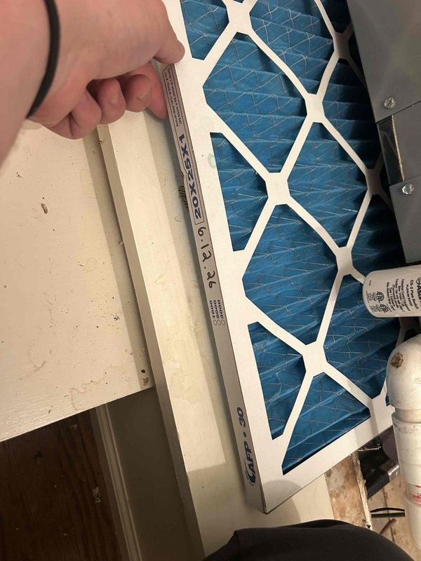 Responded to no cooling complaint on 10-11 year old geothermal system located in upstairs utility closet. Performed diagnostic evaluation of indoor air handler unit and documented current system conditions. Replaced dirty air filter that was restricting airflow to the system. Photographed equipment access area and filter replacement for service records.