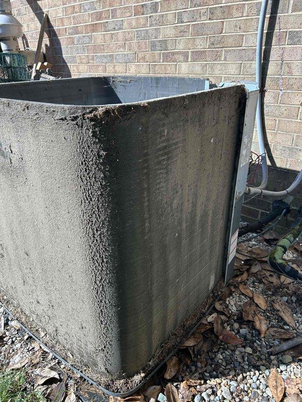 Responded to no cooling call on 15-year-old residential air conditioning system with gas heat and indoor unit located in basement. Upon arrival, performed visual inspection of outdoor condenser unit, which showed significant weathering, discoloration, and deterioration consistent with age and extended outdoor exposure. Conducted diagnostic evaluation to determine cause of warm air discharge from system. Documented equipment condition through photographic documentation showing heavy surface staining, debris accumulation, and general wear on condenser housing and surrounding area.