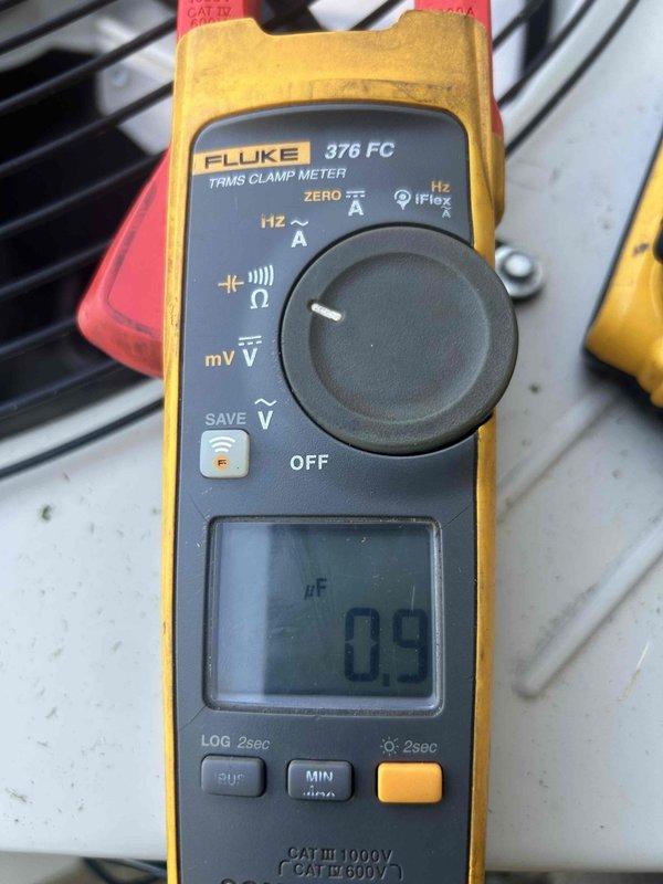 # HVAC Service Completed - Bryant Cooling System

Responded to no cooling complaint on 9-year-old Bryant split system with both indoor and outdoor units operational but lacking cool air output. Upon inspection, discovered outdoor condenser coil heavily obstructed with environmental debris, dirt, and organic material restricting proper airflow and heat transfer. Measured capacitor using Fluke 376 FC clamp meter, which tested at 09 μF, indicating capacitor failure below manufacturer specifications for this unit size.

Performed thorough condenser coil cleaning to remove accumulated debris from fins and restore proper airflow. Replaced failed run capacitor with OEM-equivalent component meeting Bryant specifications. Verified proper amperage draw on compressor and condenser fan motor post-repair. System tested and confirmed delivering proper temperature differential and cooling performance. Recommended annual maintenance to prevent future coil blockage issues.