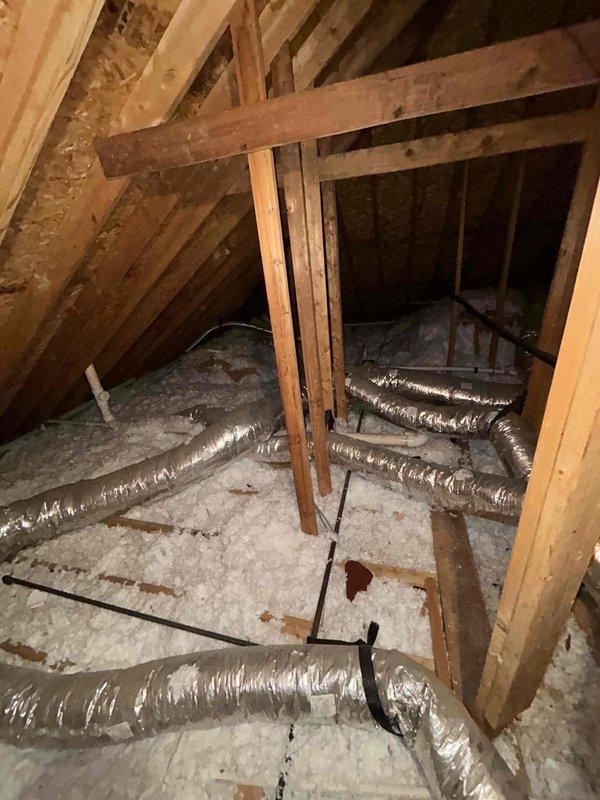 Responded to callback for recently installed system experiencing inadequate cooling performance with 5-degree temperature differential between setpoint and actual indoor temperature. Verified thermostat readings and reviewed customer-documented temperature logs spanning 6-hour period showing unit unable to maintain 74-degree setpoint during moderate outdoor conditions (87-91 degrees). 

Inspected attic installation including ductwork routing, insulation integrity, and system connections as documented in photos. Evaluated flexible duct runs for proper support, compression issues, and airflow restrictions throughout attic space. Checked all duct connections at plenum and register boots for air leakage.

Addressed secondary issue with downstairs unit where indoor blower motor operated normally but outdoor condensing unit produced humming noise without compressor engagement. Diagnosed failed run capacitor preventing compressor startup. Replaced defective dual-run capacitor with proper micr