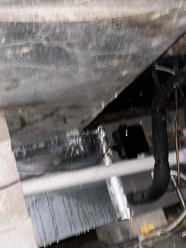 Responded to no cooling complaint on recently installed system. Found extensive ice buildup on evaporator coil and air handler components indicating severely restricted airflow. Discovered airflow obstruction causing coil to freeze completely with ice formations throughout indoor unit and ductwork. Shut down system to allow ice to thaw, identified and corrected airflow restriction. Verified proper refrigerant charge on 454B system, checked static pressures, and confirmed adequate airflow across coil. System returned to normal operation with proper cooling performance and temperature split after correcting airflow issue that caused freezing condition.