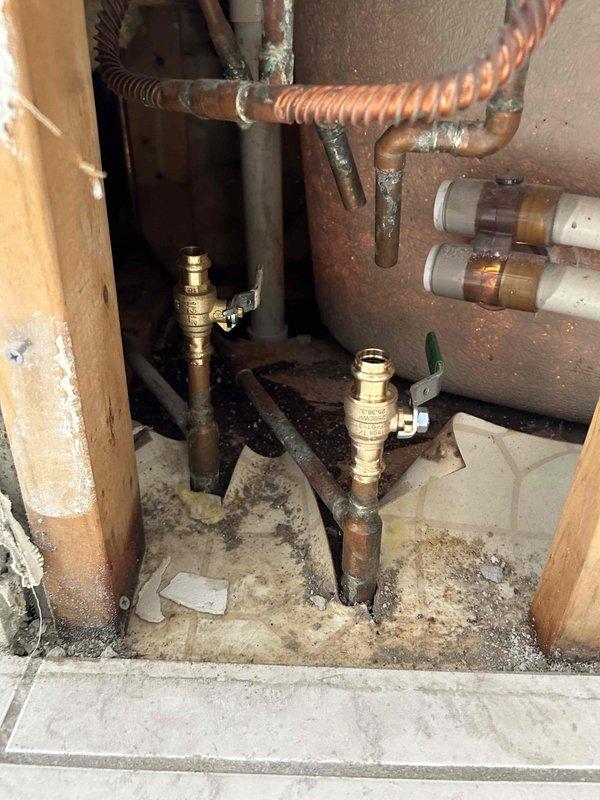 Responded to callback for new issues following recent bathtub leak diagnosis. Performed thorough inspection of tub drain assembly, overflow, and supply line connections in accessible areas below fixture. Accessed plumbing chase and examined previously inspected copper supply lines, shut-off valves, and drain shoe assembly for any changes in condition or new leak sources. Documented current state of installation with photography showing access point beneath tub and fixture deck area. No active leaks observed during inspection. Consulted with customer regarding new concerns and confirmed all accessible plumbing components remain secure and functional at time of visit.