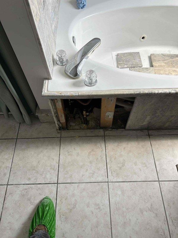 Responded to callback for new issues following recent bathtub leak diagnosis. Performed thorough inspection of tub drain assembly, overflow, and supply line connections in accessible areas below fixture. Accessed plumbing chase and examined previously inspected copper supply lines, shut-off valves, and drain shoe assembly for any changes in condition or new leak sources. Documented current state of installation with photography showing access point beneath tub and fixture deck area. No active leaks observed during inspection. Consulted with customer regarding new concerns and confirmed all accessible plumbing components remain secure and functional at time of visit.