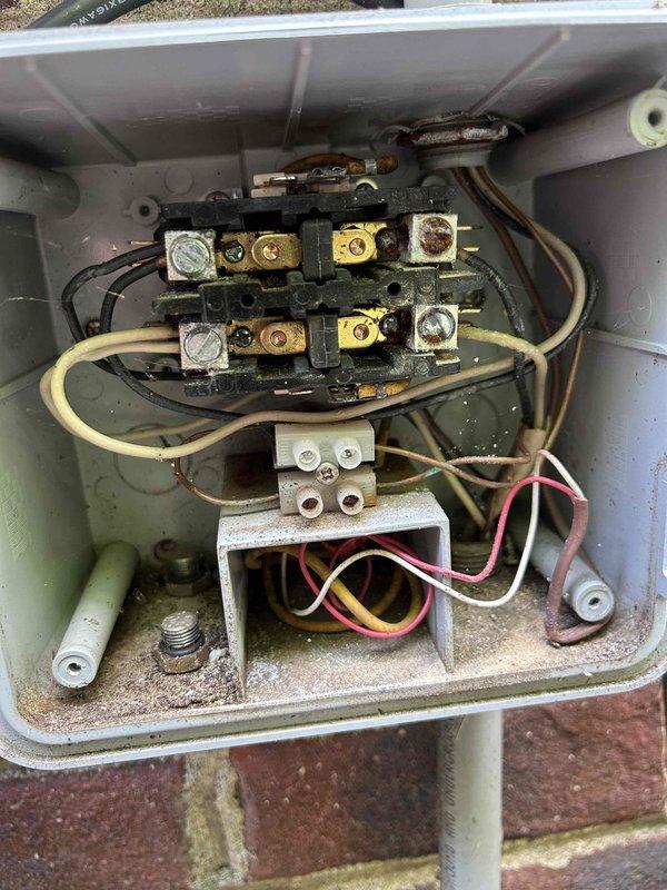 Responded to service call for non-functioning irrigation system and flickering landscape lighting. Diagnosed electrical issues in irrigation control panel and timer system. Found heavily corroded terminal blocks and oxidized brass terminals in outdoor junction boxes affecting system operation. Inspected control module, relay components, and terminal connections showing significant weathering and debris accumulation. Addressed wiring connections and electrical components to restore proper function to irrigation system and landscape lighting zone.