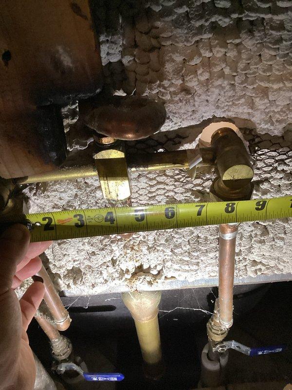Responded to service call for dripping tub/shower valve. Accessed plumbing through hallway panel behind shower wall. Inspected copper supply lines and valve assembly beneath structure, measuring pipe configurations and assessing existing fixtures. Evaluated aged brass shower valve, tub spout, and control valves showing significant wear and tarnishing. Determined valve required full replacement rather than rebuild due to condition. Replaced defective shower valve assembly with new unit, ensuring proper connections to existing copper supply lines. Tested system for leaks and verified proper operation of all controls.