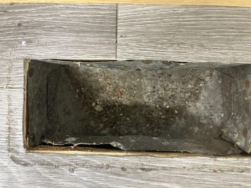 Responded to service call regarding suspected mold growth in ventilation system. Upon inspection, discovered heavily soiled deck vent with significant accumulation of dirt, dust, and debris rather than mold contamination. Inspected basement mechanical room containing dual furnace units, ductwork, and associated HVAC components; found no evidence of mold growth throughout the system or in connected ductwork and vents, confirming issue was isolated to single exterior deck vent opening with normal environmental debris buildup.