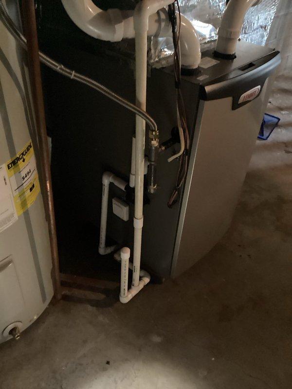 Responded to basement floor drain clog located near furnace and water heater. Upon arrival, observed standing water and puddling at drain opening, indicating blockage in drainage system. Assessed that clog was isolated to floor drain line rather than HVAC condensate system. Cleared obstruction from basement floor drain using appropriate drain cleaning equipment. Verified proper water flow and drainage upon completion. Drain now functioning normally with no standing water present.