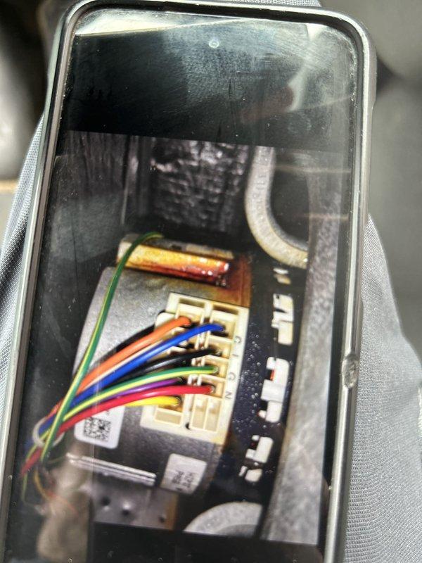 Responded to no cooling call on 3-year-old electric heat pump system with indoor blower motor failure. Upon arrival, confirmed indoor air handler blower was not operating. Accessed air handler cabinet located near side door and performed diagnostic evaluation of blower motor circuit and control board. Inspected wiring connections at control board terminals, checked capacitor condition, and verified power supply to motor assembly. Documented existing equipment conditions including control board configuration, wire connections, and component layout with photographs for service records. Identified blower motor circuit malfunction preventing system operation and provided repair recommendations to restore cooling function.