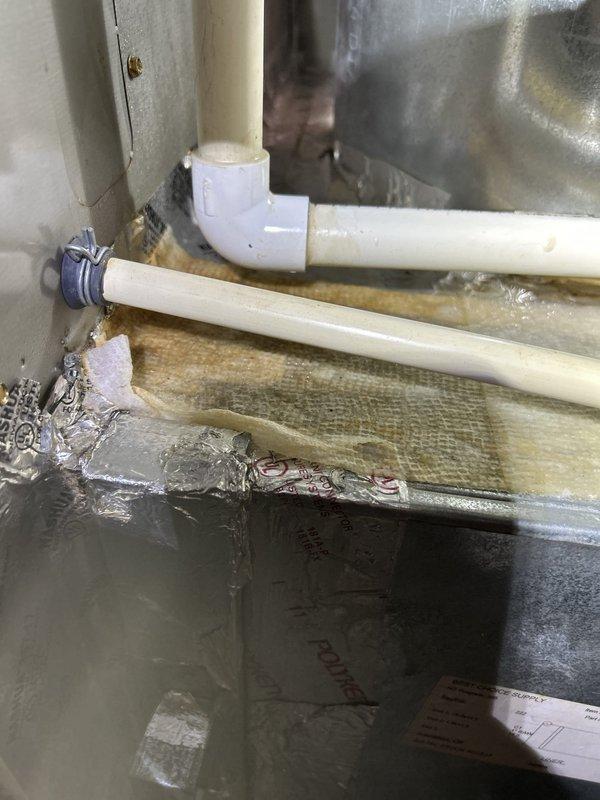 Responded to no cooling call on 10-year-old gas furnace system with indoor unit located in basement. Upon arrival, indoor temperature had reached 80 degrees and system was completely non-responsive despite no tripped breakers. Performed diagnostic evaluation of the air conditioning system, which had a capacitor replacement completed in July. Inspected control board circuitry, wiring connections, and electrical components to identify failure point preventing system operation. Documented equipment condition including condensate drainage piping, ductwork configuration, and internal control board assembly with terminal connections for service records and warranty purposes.