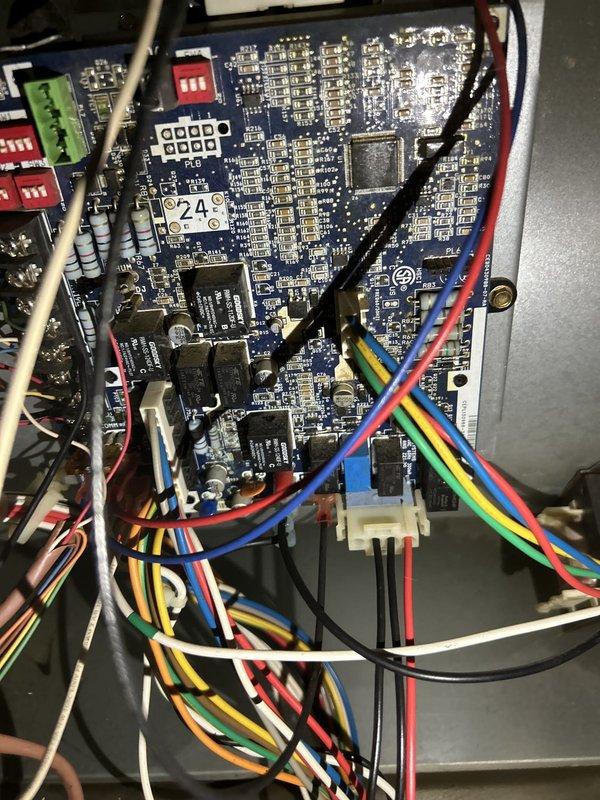 Responded to no cooling call on 10-year-old gas furnace system with indoor unit located in basement. Upon arrival, indoor temperature had reached 80 degrees and system was completely non-responsive despite no tripped breakers. Performed diagnostic evaluation of the air conditioning system, which had a capacitor replacement completed in July. Inspected control board circuitry, wiring connections, and electrical components to identify failure point preventing system operation. Documented equipment condition including condensate drainage piping, ductwork configuration, and internal control board assembly with terminal connections for service records and warranty purposes.