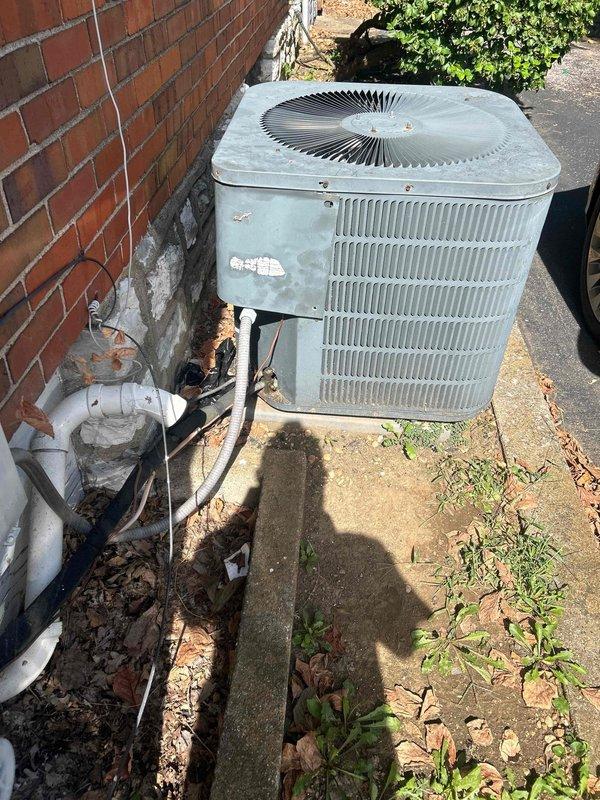 Performed second opinion evaluation on 18-year-old residential air conditioning system with no cooling condition. Confirmed previous diagnosis of evaporator coil leak in basement-mounted air handler unit. Assessed outdoor condenser unit showing significant age-related deterioration including weathered housing, damaged PVC line set covers with visible cracks and peeling material, and accumulated debris around unit. Provided comprehensive replacement estimate for complete HVAC system due to age of equipment exceeding typical service life and cost-effectiveness of replacement versus repair on failed refrigerant coil.