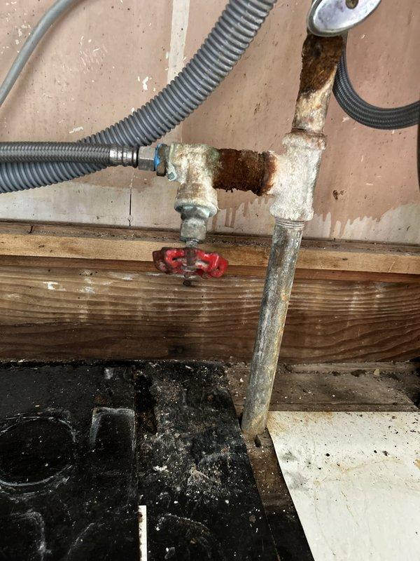 Responded to a broken water line supplying the dishwasher. Upon arrival, water was already shut off to the entire house. Accessed the plumbing in the basement utility area where the dishwasher supply line connects to the main water system. Replaced corroded pipe fittings and installed new dual shut-off valve assembly with cross-handle controls mounted to the floor joist. Connected new braided stainless steel flex line to supply dishwasher, replacing the failed water line. Tested system for leaks after restoring water pressure and verified proper operation of both shut-off valves.