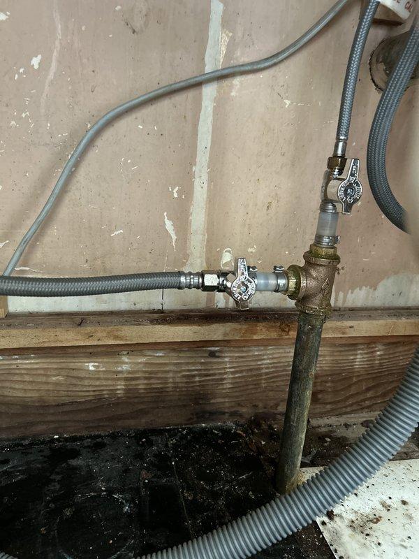 Responded to a broken water line supplying the dishwasher. Upon arrival, water was already shut off to the entire house. Accessed the plumbing in the basement utility area where the dishwasher supply line connects to the main water system. Replaced corroded pipe fittings and installed new dual shut-off valve assembly with cross-handle controls mounted to the floor joist. Connected new braided stainless steel flex line to supply dishwasher, replacing the failed water line. Tested system for leaks after restoring water pressure and verified proper operation of both shut-off valves.