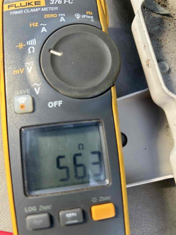 Responded to no-cool call on 7-year-old electric air conditioning system serving third floor space. Unit was displaying CH21/CH35 error codes and not operating. Performed diagnostic testing on ceiling-mounted air handler, documented equipment nameplate information showing manufacture date of November 2010, and measured resistance readings of 56.3 ohms during electrical component testing to isolate fault condition.