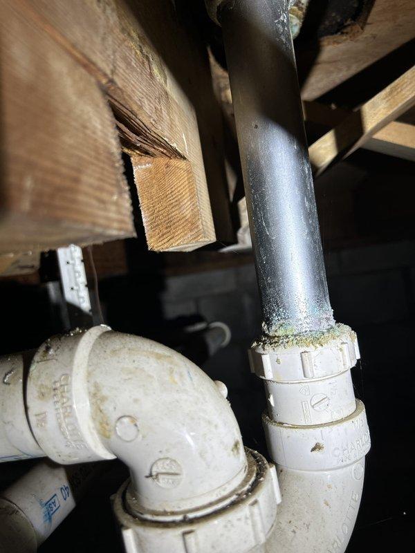 Completed comprehensive plumbing inspection of residential crawlspace and basement areas as part of routine preventive maintenance assessment. Inspected all visible plumbing components including vertical drain lines, PVC connections, pipe joints, and transition points between different piping materials. Documented condition of existing plumbing infrastructure with photographic evidence showing older metal pipe connections to newer PVC systems, including threaded couplings and elbow joints in attic/crawlspace area with visible age-related discoloration and minor surface wear within normal parameters for system age.