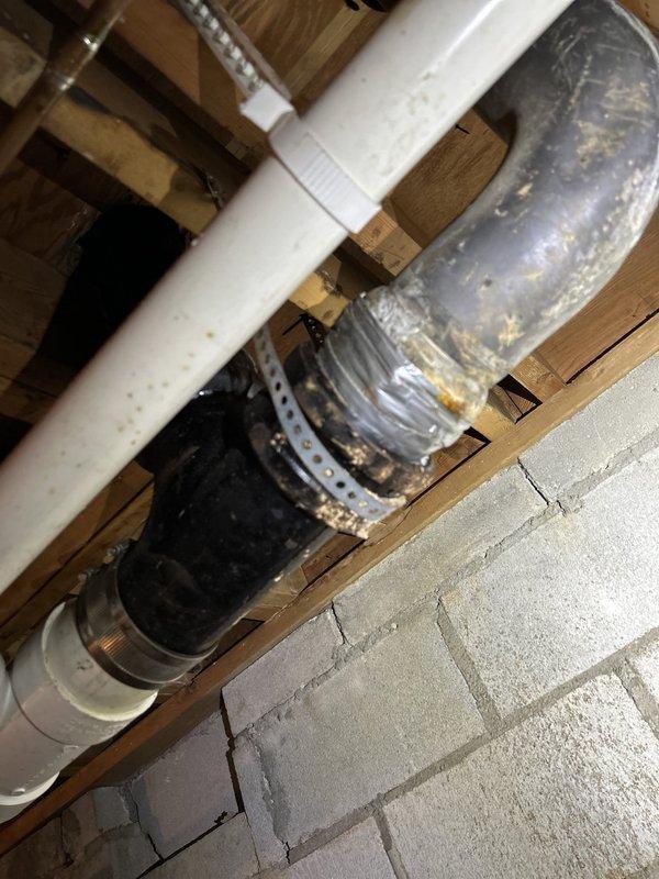 Completed comprehensive plumbing inspection of residential crawlspace and basement areas as part of routine preventive maintenance assessment. Inspected all visible plumbing components including vertical drain lines, PVC connections, pipe joints, and transition points between different piping materials. Documented condition of existing plumbing infrastructure with photographic evidence showing older metal pipe connections to newer PVC systems, including threaded couplings and elbow joints in attic/crawlspace area with visible age-related discoloration and minor surface wear within normal parameters for system age.