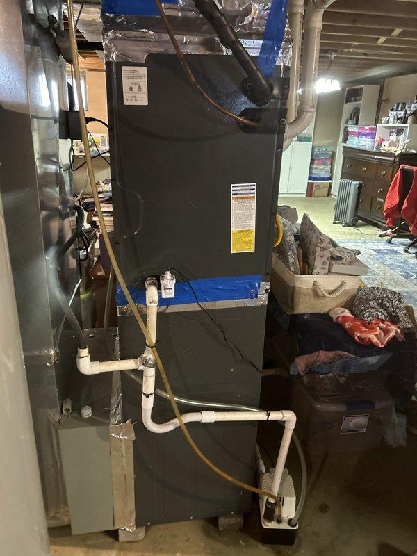 Responded to no cooling complaint on gas furnace system with basement-located air handler experiencing repeated coil freeze-ups. Unit had frozen approximately three weeks prior with temporary resolution after filter replacement, but freezing recurred within 24 hours of restart. Upon arrival, system was off and thawing. Performed comprehensive diagnostic evaluation using digital manifold gauge set to measure R-410A refrigerant pressures and temperatures across the system. Recorded suction line temperature of 46.5°F, liquid line temperature of 24.7°F, and superheat reading of 7.12°F with ambient conditions at 90.6°F. Low superheat measurement indicated potential refrigerant overcharge or restriction in the system. Inspected evaporator coil access, condensate drain lines, and PVC drainage system for blockages or improper flow. Evaluated airflow across indoor coil and verified filter condition. Checked blower motor operation and static pressure readings to rule out airflow restrictions as 