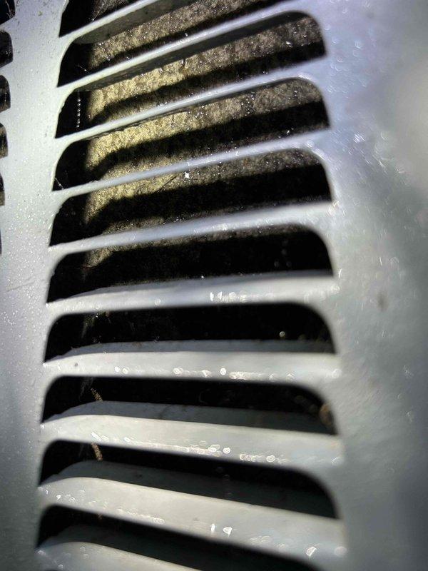 Responded to service call for 6-year-old mini-split system producing grinding noise while maintaining cooling capacity. Performed diagnostic inspection of outdoor condenser unit and indoor air handler. Identified significant dust and debris accumulation on indoor unit's air filter and ventilation grille restricting airflow. Cleaned and serviced indoor evaporator coil and blower assembly, removing substantial buildup causing mechanical strain and abnormal operating sounds. Inspected outdoor condenser unit for mechanical wear, verified refrigerant levels, and tested system operation. Unit now operating quietly within normal parameters with restored airflow and no grinding noise present.