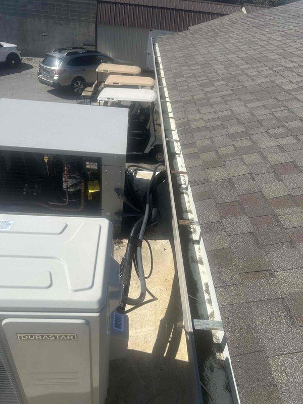 Completed installation of Durastar 18,000 BTU single zone mini split system including outdoor condensing unit mounted on rooftop with pad and snow legs, and wall-mounted indoor air handler. Installed 50-foot refrigerant line set with 1/4" x 1/2" copper lines with insulation, ran electrical whip with disconnect box, and installed dedicated 230V/20A electrical circuit with breaker. System was evacuated, charged, tested, and verified operational with all electrical connections secured and code compliant.