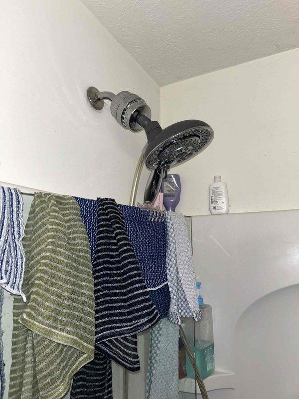 Completed routine plumbing inspection in conjunction with HVAC maintenance visit. Performed visual assessment of bathroom fixtures including shower assembly and under-sink plumbing components. Inspected chrome shower head, mounting hardware, and supply connections for proper operation and signs of leaks or deterioration. Examined under-sink cabinet area, verifying P-trap configuration, PVC drain assembly, and all pipe connections for integrity and proper sealing. All plumbing fixtures and connections found to be functioning properly with no visible leaks, corrosion, or immediate service needs identified.