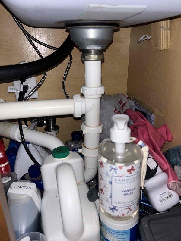 Completed routine plumbing inspection in conjunction with HVAC maintenance visit. Performed visual assessment of bathroom fixtures including shower assembly and under-sink plumbing components. Inspected chrome shower head, mounting hardware, and supply connections for proper operation and signs of leaks or deterioration. Examined under-sink cabinet area, verifying P-trap configuration, PVC drain assembly, and all pipe connections for integrity and proper sealing. All plumbing fixtures and connections found to be functioning properly with no visible leaks, corrosion, or immediate service needs identified.