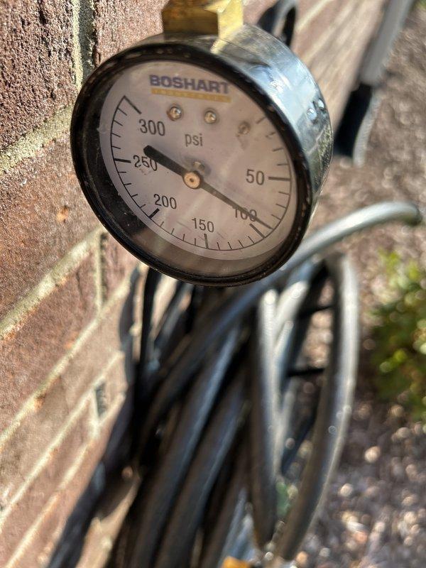 Completed routine plumbing inspection coordinated with HVAC service. Inspected and documented water pressure gauge reading at approximately 250 psi on main supply line, verified proper operation of angle stop valve and supply line connections at fixture location. All components found in working condition with normal wear patterns noted.