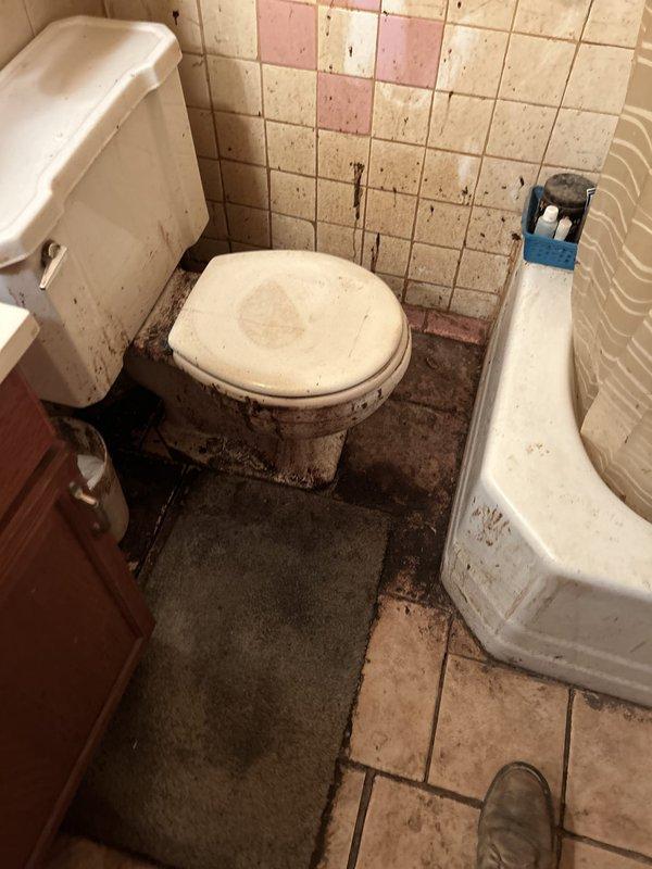 Responded to service call for clogged toilet backing up into bathtub. Upon arrival, found severe drainage blockage affecting bathroom plumbing system, with contaminated water backing up from toilet into tub basin. Cleared main drain line obstruction using professional drain clearing equipment. Restored proper drainage flow to both toilet and bathtub fixtures. Tested system to verify complete clearance and proper function of all affected fixtures.
