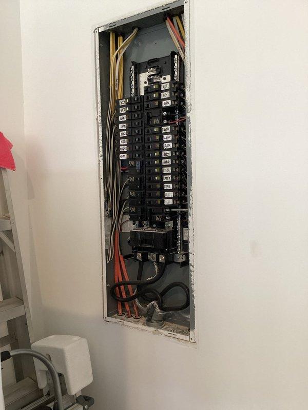 Conducted comprehensive electrical system evaluation for propane generator integration and circuit breaker panel assessment. Customer reported ongoing issues with power surges causing circuit breakers to trip repeatedly. Performed thorough inspection of existing main electrical panel and exterior meter assembly to diagnose surge-related problems and determine system capacity for generator installation. Documented current panel configuration, breaker layout, wire routing, and meter specifications. Provided detailed estimate for propane-fueled standby generator installation including required electrical connections, transfer switch integration, and necessary panel upgrades to resolve power surge issues and ensure reliable backup power operation.
