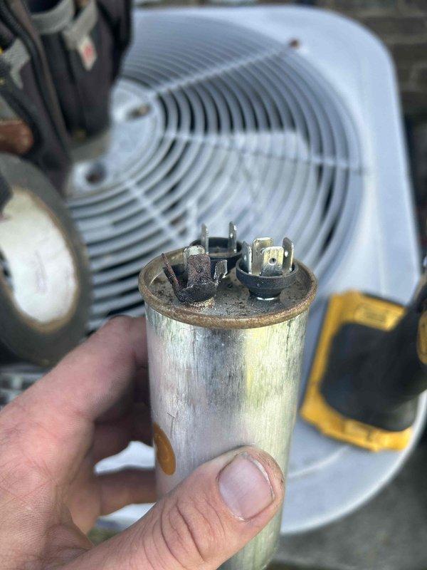 Responded to callback for loud humming noise during system startup. Diagnosed failed run capacitor showing visible deterioration, dirt accumulation, and electrical stress on terminals. Replaced defective capacitor with new component, verified proper wire connections, and tested system operation. Unit now cycles on quietly without abnormal noise, resolving the issue unrelated to previous service call.