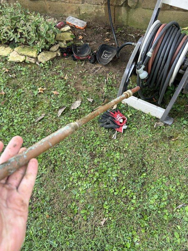 Replaced leaking outdoor spigot with new fixture after accessing the copper supply line through interior crawl space. Removed deteriorated exterior hose bib that exhibited significant oxidation and patina, then installed new frost-free sillcock to prevent future leaks and ensure proper water flow to outdoor hose connection.