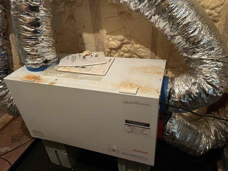 Performed maintenance inspection on dual geothermal split system with units located in attic and basement. Conducted pressure diagnostics and system performance verification on attic unit, which showed evidence of water damage and staining on exterior casing. Verified refrigerant pressures using manifold gauge set and inspected brass fittings, copper line connections, and electrical components for proper operation. Documented filter specifications as 16x25x4 for customer replacement and noted previous water intrusion affecting filter condition.