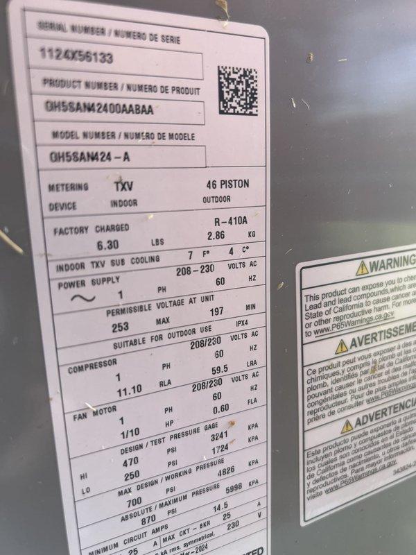 Responded to no cooling complaint on 3-year-old Goodman air conditioning system. Upon arrival, coordinated access with property owner due to temporary bridge closure affecting primary route. Performed system diagnostic and found REME-HALO air purification unit requiring attention. Inspected outdoor condensing unit (Model GH55AM24-A, Serial 1126456133) and verified R-410A refrigerant charge at factory specification of 6.30 lbs. System restored to proper cooling operation and customer notified of UV bulb replacement recommendation for the REME-HALO unit.