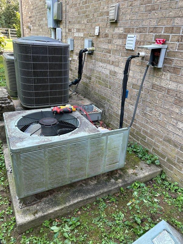 Responded to no cooling complaint on 20-year-old electric Rheem HVAC system with indoor unit located in basement. Performed diagnostic evaluation and determined existing outdoor condenser unit was experiencing overheating issues and system failure. Due to age of equipment and extent of mechanical failure, provided comprehensive replacement estimate for complete system upgrade. Documented existing equipment configuration including outdoor unit placement, electrical connections, refrigerant line routing, and wall-mounted components for replacement planning purposes.