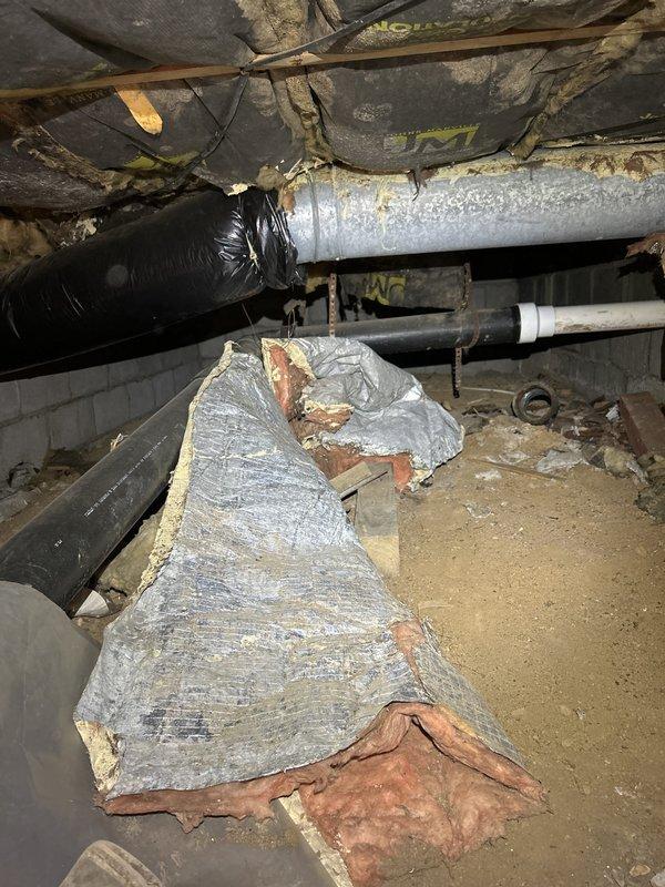 Completed comprehensive plumbing inspection of residential property as part of routine maintenance protocol. Conducted thorough examination of accessible plumbing systems including crawl space utilities and exposed pipe connections. Inspected condition of water supply lines, drainage systems, and pipe joints throughout accessible areas.

During crawl space inspection, documented existing conditions of plumbing infrastructure running through subfloor area. Observed various pipe materials including PVC and metal piping in overhead configuration. Noted presence of moisture indicators and mineral deposits on metal pipe fittings, particularly at connection points showing white crystalline efflorescence buildup consistent with long-term water exposure. Examined corroded pipe joints displaying oxidation and age-related deterioration with brown-gray patina on metal surfaces.

Assessed overall plumbing system integrity and identified areas showing normal wear patterns associated with aging infr