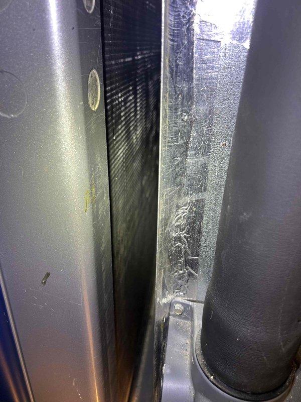 Completed comprehensive HVAC maintenance on a 16-year-old air conditioning system, including installation of a compressor saver kit to extend equipment life and improve efficiency. Performed AC tune-up procedures, cleaned steam humidifier components, and serviced dehumidifier unit using customer-provided canister and dynamic filters. Documented existing equipment condition showing dust accumulation on air handler components and ductwork, with photos capturing the attic-mounted unit, metallic transition plenum, flexible aluminum ductwork, and PVC condensate drainage system.