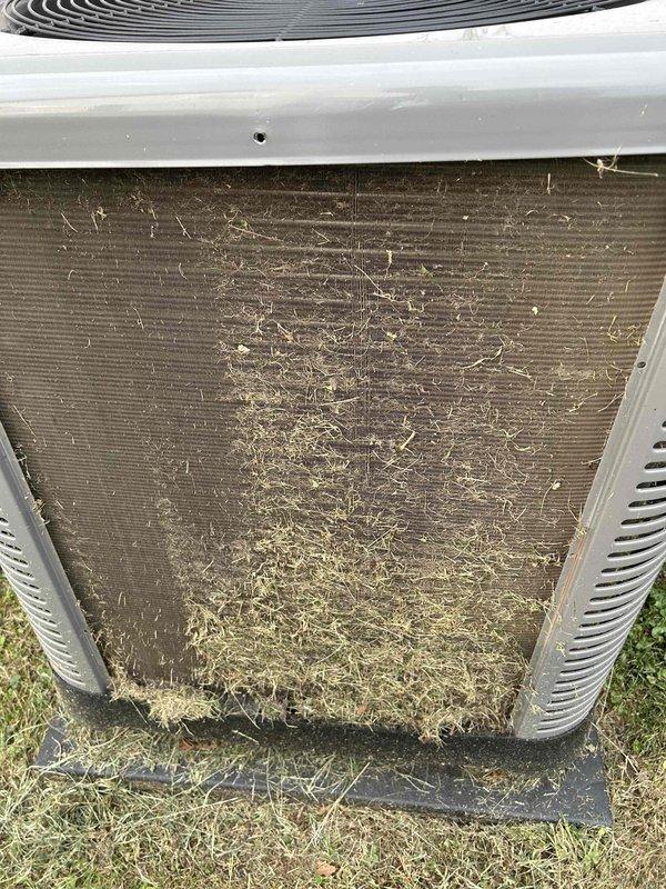 Completed Club Single maintenance on outdoor heat pump unit. Condenser coil exhibited heavy debris accumulation consisting of grass clippings, leaves, and organic matter obstructing airflow through fins. Cleaned condenser coil thoroughly to restore proper heat exchange efficiency and airflow. Performed standard maintenance inspection of unit components including fan operation and cabinet condition. Unit operational upon completion of service.