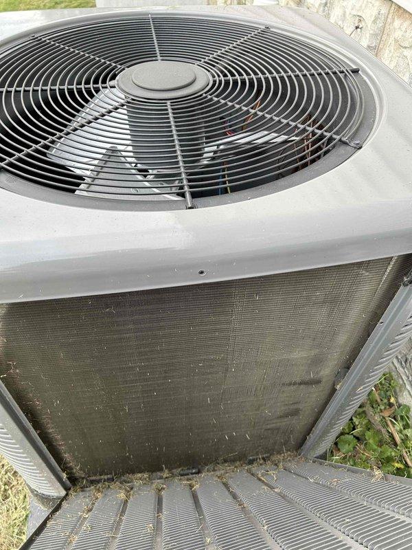 Completed Club Single maintenance on outdoor heat pump unit. Condenser coil exhibited heavy debris accumulation consisting of grass clippings, leaves, and organic matter obstructing airflow through fins. Cleaned condenser coil thoroughly to restore proper heat exchange efficiency and airflow. Performed standard maintenance inspection of unit components including fan operation and cabinet condition. Unit operational upon completion of service.