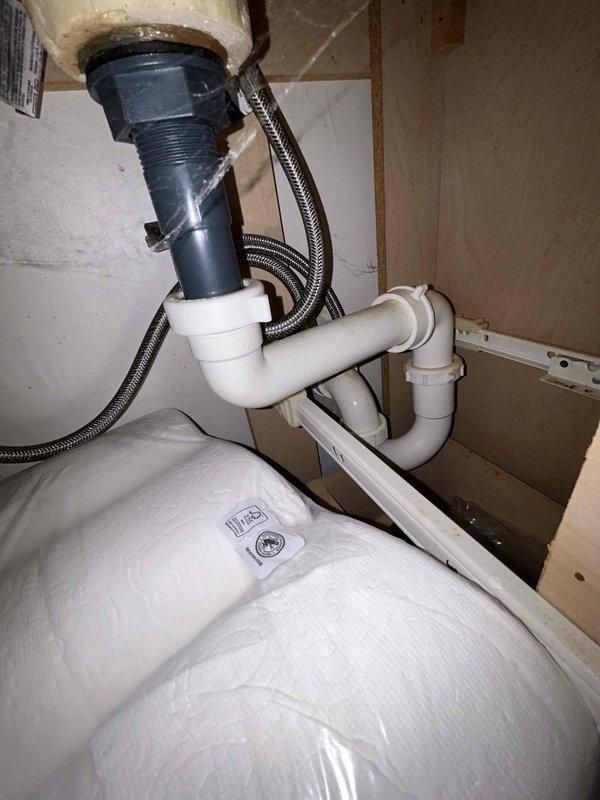 Completed complimentary plumbing inspection in coordination with HVAC service appointment. Performed visual inspection of bathroom fixtures including toilet and under-sink plumbing assembly, verifying proper installation of garbage disposal unit, P-trap configuration, water supply lines, and drain connections. All components found in satisfactory operating condition with no leaks or immediate concerns identified.