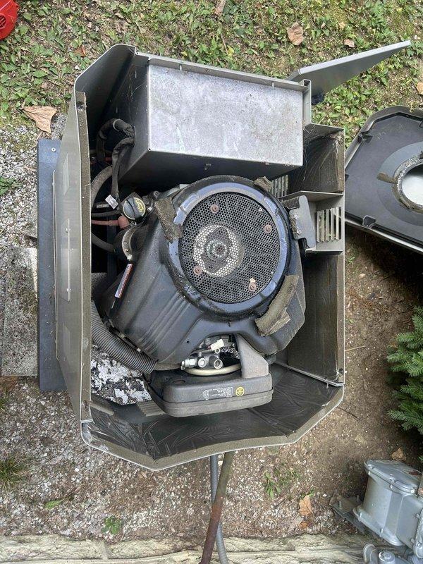 Completed routine maintenance inspection on GE standby generator unit. Documented current equipment condition through comprehensive photography of generator housing, internal engine components including air filter assembly, transfer switch location, electrical conduit routing, and mounting configuration. Captured detailed measurements and installation specifications as requested for potential future equipment replacement evaluation.