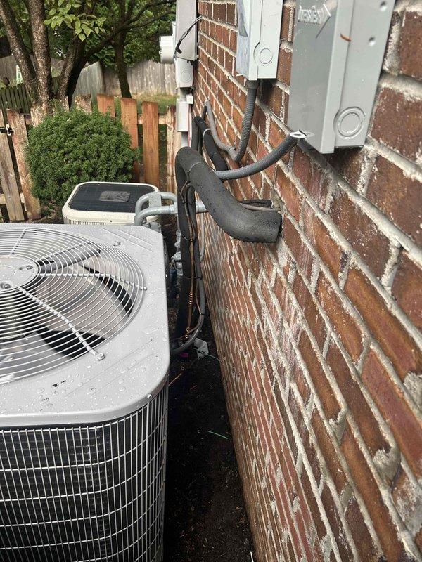 Completed full residential HVAC system installation consisting of a Bryant 2-ton 14.3 SEER2 single-stage air conditioning unit (model GA5SAN52400A) with matching evaporator coil (model CVAMA2417XMA). Removed and properly disposed of existing equipment per code requirements.

Installed outdoor condensing unit on new concrete pad in side yard area with refrigerant lines routed up exterior brick wall using proper mounting brackets and insulation. Installed electrical disconnect box on exterior wall and connected unit with electrical whip kit. Applied insulation to all refrigerant lines and installed refrigerant line filter drier for system protection.

In attic space, installed evaporator coil with proper transitions to existing ductwork using insulated flexible duct connections. Installed black drain pan beneath coil assembly to catch condensation. Integrated SS2 coil drain safety water sensor for overflow protection. Secured all ductwork connections with metallic tape and verified prope