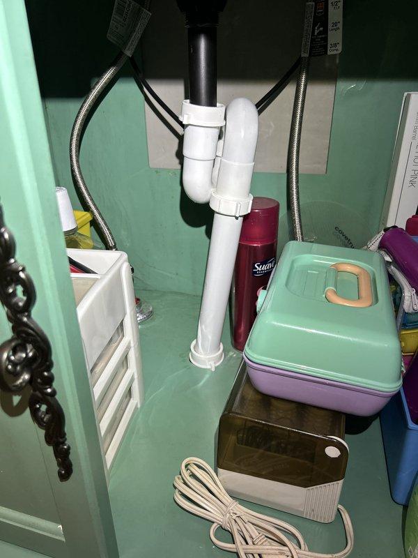 Completed routine plumbing inspection as part of scheduled preventative maintenance service. Inspected bathroom vanity plumbing including PVC P-trap assembly, black vertical drain pipe, and flexible braided stainless steel supply lines, confirming all connections were secure and functioning properly with no visible leaks. Verified exterior water pressure gauge mounted on brass fitting, noting gauge reading at approximately 0 psi at time of inspection. All accessible plumbing components were visually examined and found to be in satisfactory operating condition.