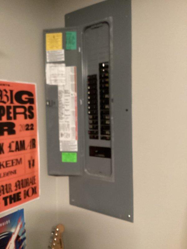 Conducted electrical estimate for car charging station installation with charger placement in garage and breaker panels located in basement and upstairs areas. Assessed existing electrical infrastructure by inspecting main breaker panel, documented panel capacity and available circuit positions, and evaluated routing requirements for dedicated charging circuit from basement panel to garage location. Photographed electrical panel configuration and exterior building structure to determine optimal conduit pathway and installation approach for Level 2 charging station.