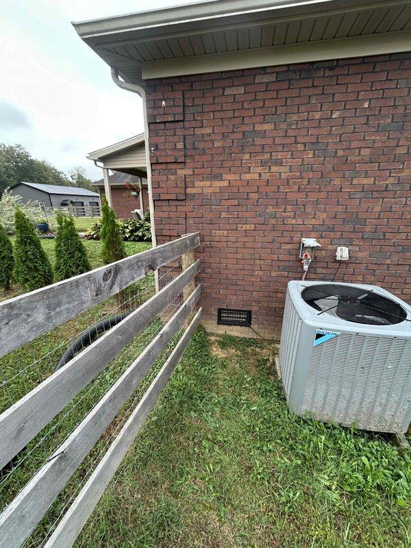 Conducted comprehensive electrical assessment for residential rewiring project at brick exterior property. Evaluated existing electrical infrastructure including exterior-mounted electrical boxes and outlets on brick wall near HVAC condensing unit. Inspected electrical connections and conduit routing for air conditioning system, examining both exterior junction boxes and internal electrical components within mechanical equipment housing. Documented current wiring configuration, insulated line sets, and electrical service connections to support rewiring estimate and scope of work development.